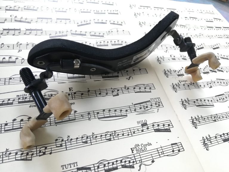 a shoulder rest lying on some sheet music