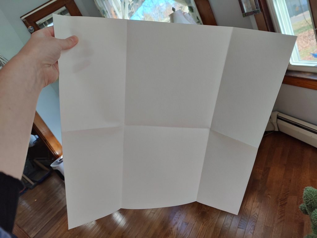 holding white green cloth unfolded