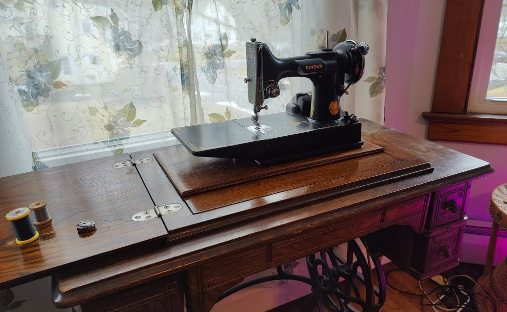 collection of vintage sewing machines singer featherweight on antique table