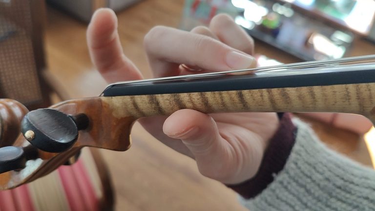 Why do violinists wiggle their fingers? A comprehensive overview of vibrato